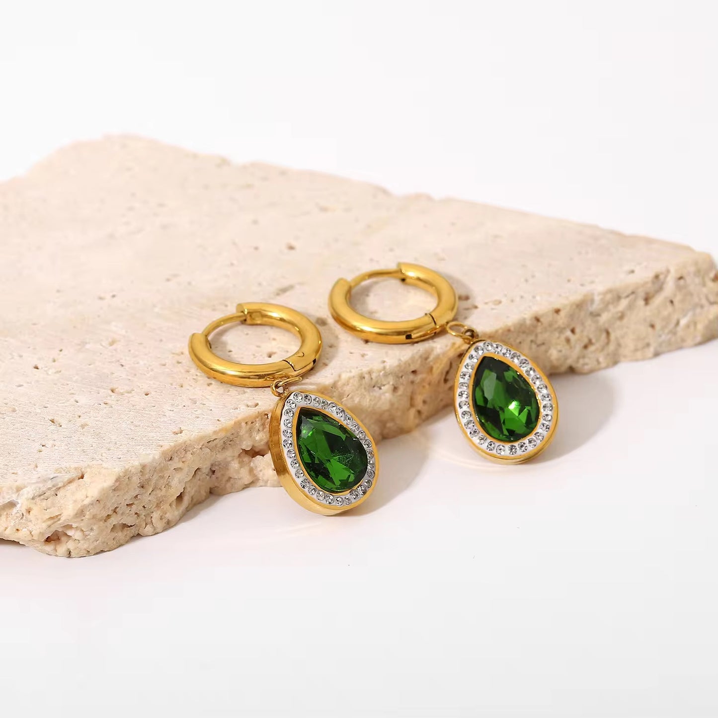 Bring timeless charm to your look with our Crystal Teardrop Huggie Earrings, available in Maroon, Green, and Pink.
