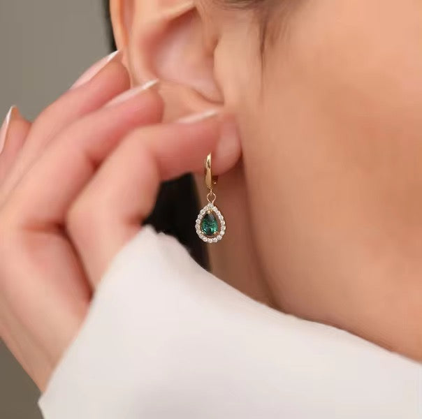 Bring timeless charm to your look with our Crystal Teardrop Huggie Earrings, available in Maroon, Green, and Pink.