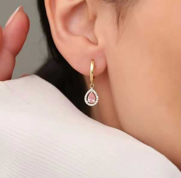 Bring timeless charm to your look with our Crystal Teardrop Huggie Earrings, available in Maroon, Green, and Pink.