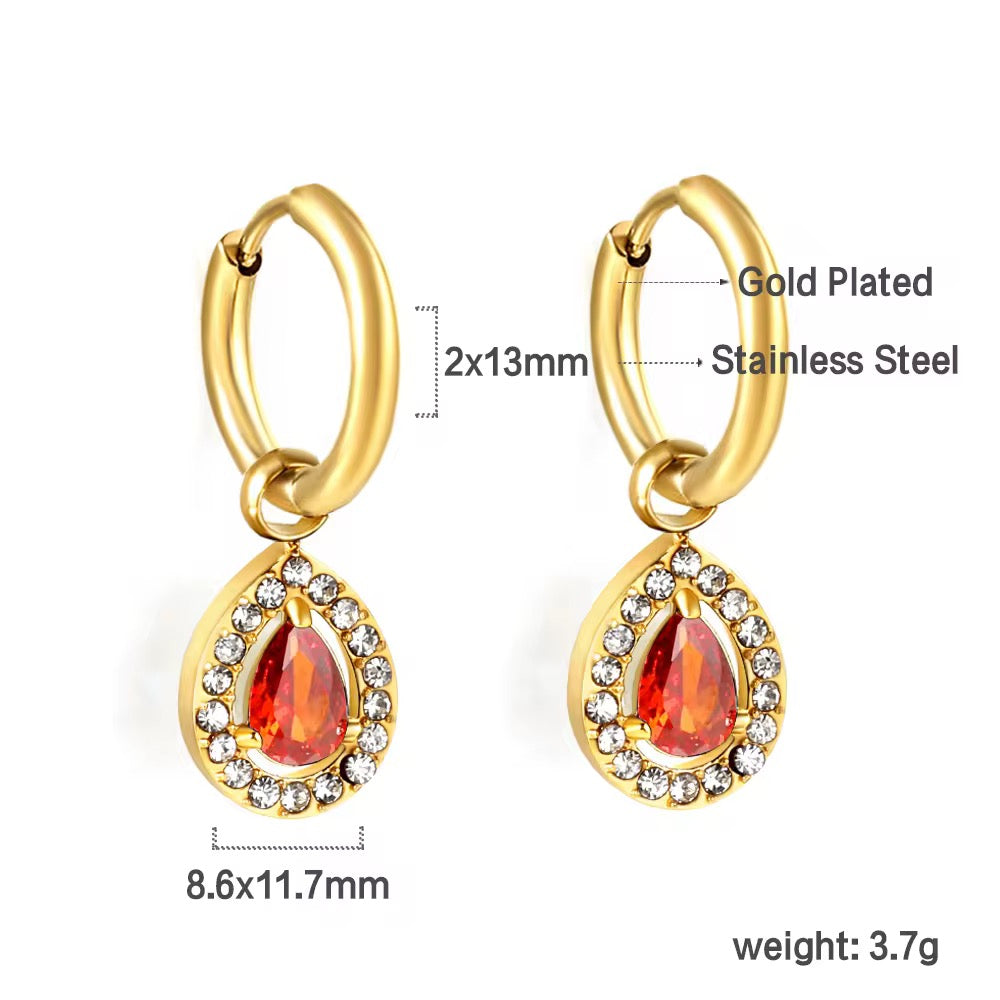 Bring timeless charm to your look with our Crystal Teardrop Huggie Earrings, available in Maroon, Green, and Pink.